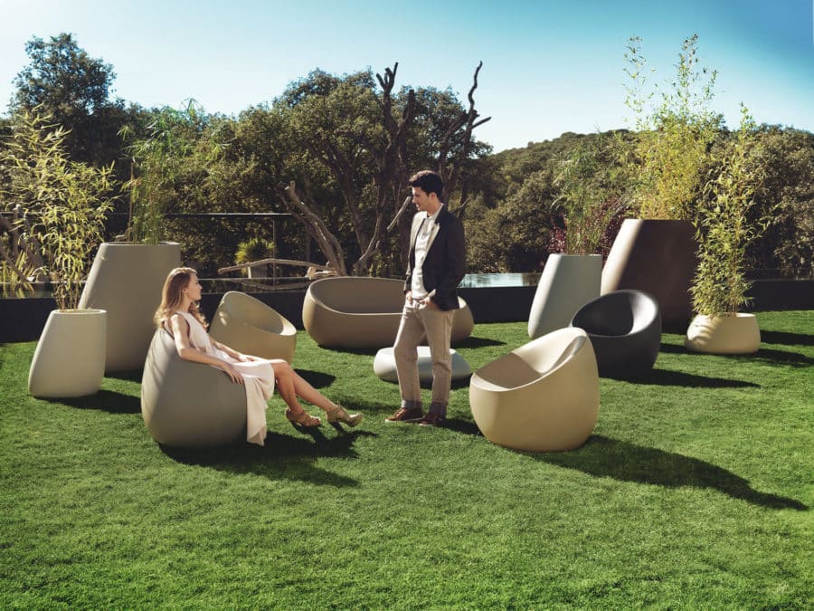 Vondom - STONE collection showing sofa, lounge chairs in many colors, coffee table, and various planters